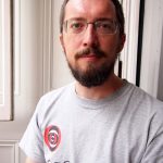 Bearded bespectacled man wearing a t-shirt