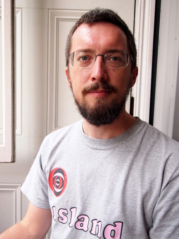 Bearded bespectacled man wearing a t-shirt