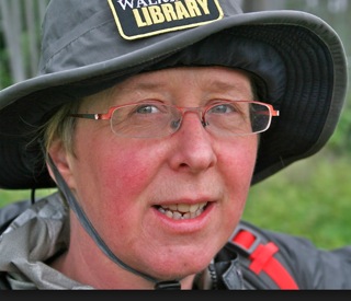 Bespectacled woman with branded hat