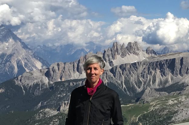 Standing woman with mountain backdrop