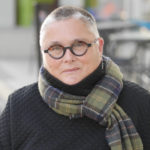 Bespectacled woman wearing a scarf