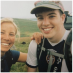 Blonde woman leans on the shoulder of a young man